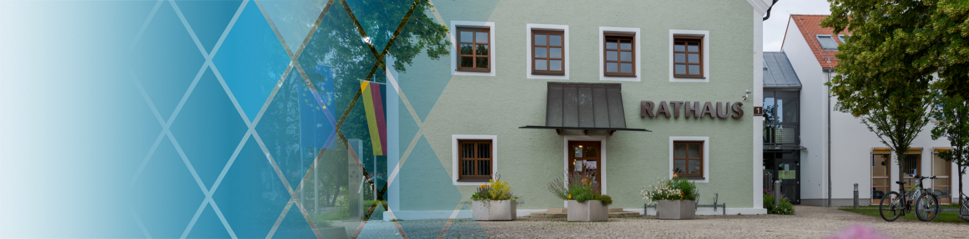 Demografieleitfaden Kopfbild Kommunen - Frontalansicht des Rathauses einer kleineren bayerischen Kommune mit dem Schriftzug 'Rathaus' neben dem Eingang
